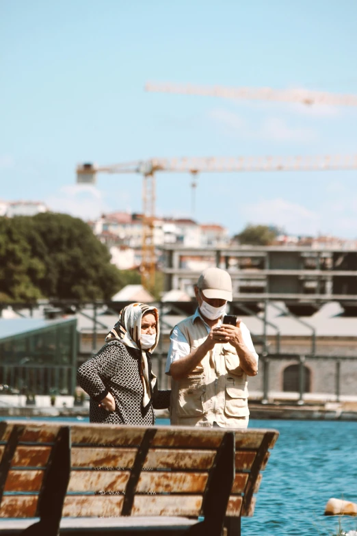 two people are looking at a po in front of the camera