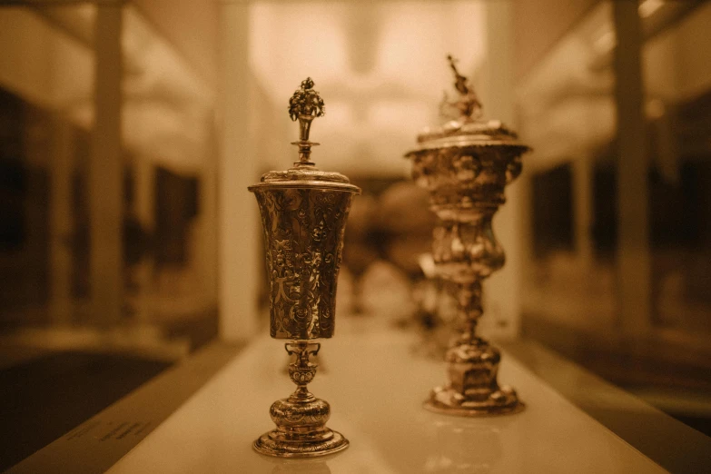 three pews on display lined up in an ornate hall