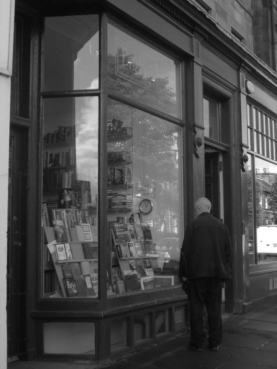 a person is standing in front of a book store