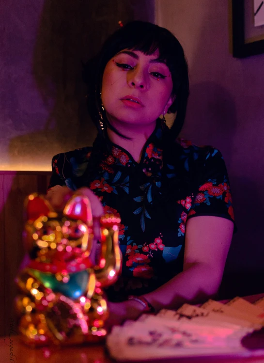 a woman standing in front of some cakes