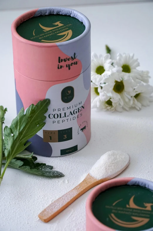 a toothbrush and canister of tooth paste sitting next to flowers