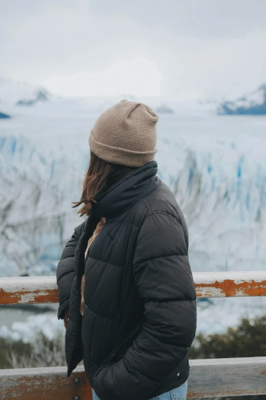 woman at viewpoint of glacier view in winter