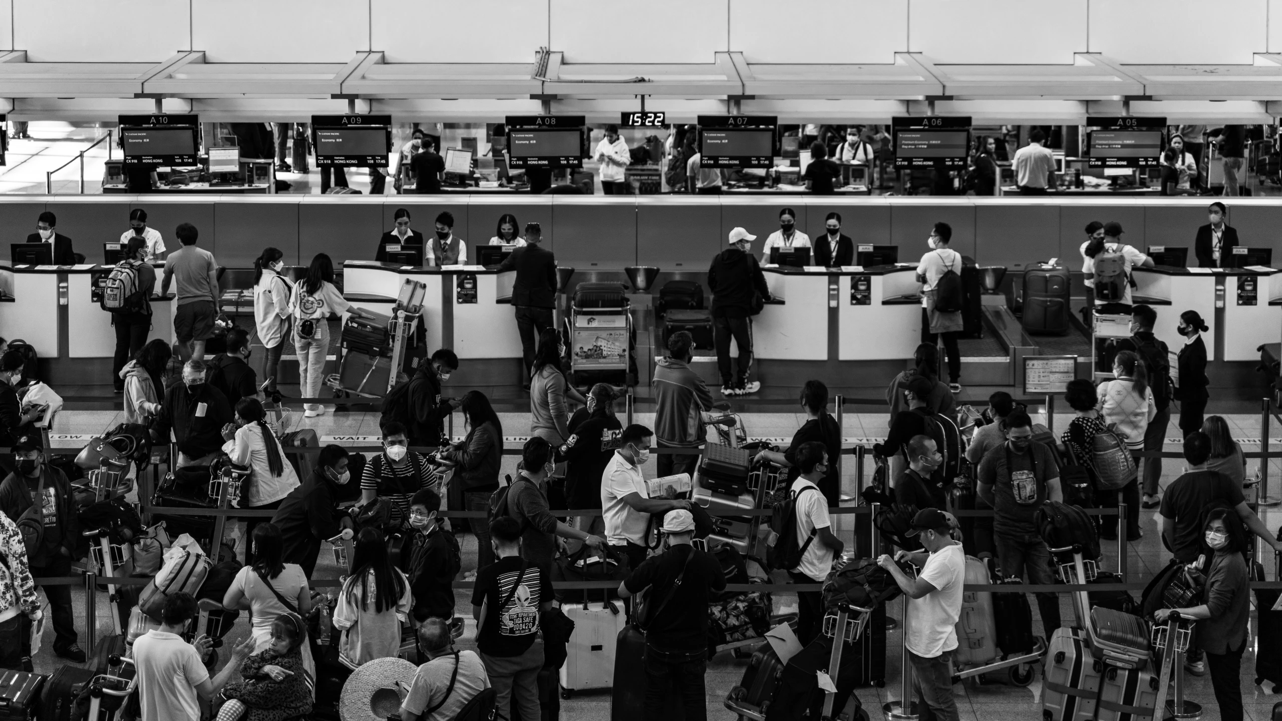 a group of people waiting around luggage at the airport