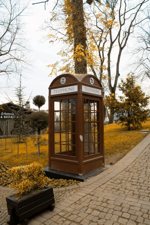 the small booth stands alone on the sidewalk