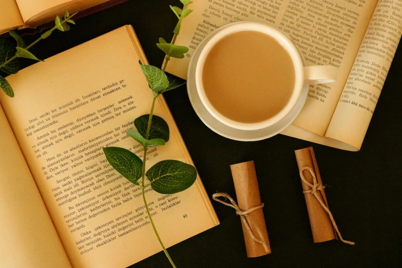 a cup of coffee sits on top of an open book