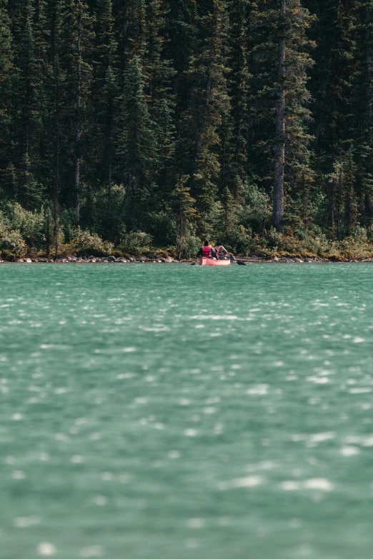 an image of two people in a boat on a lake