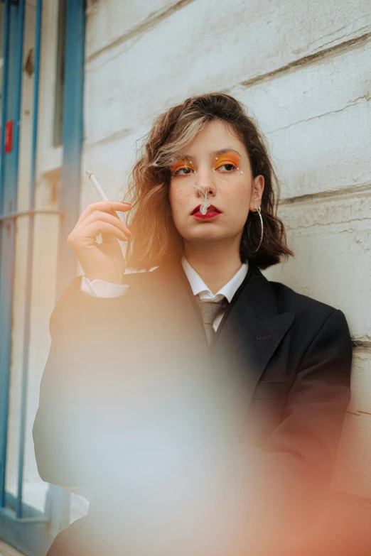 a woman in a business suit smoking a cigarette