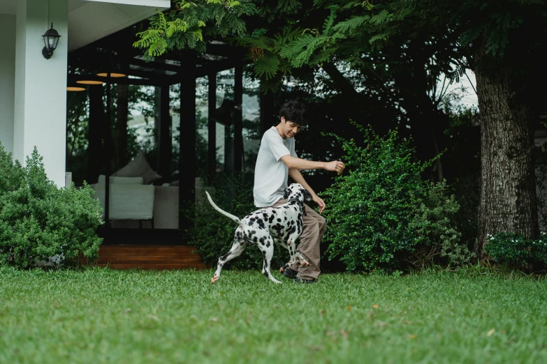 a man riding on the back of a dog on top of grass