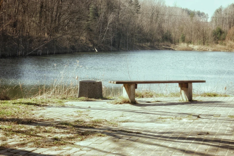 a bench near a river in the country side