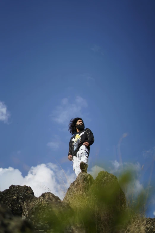 there is a man that is standing on top of a mountain