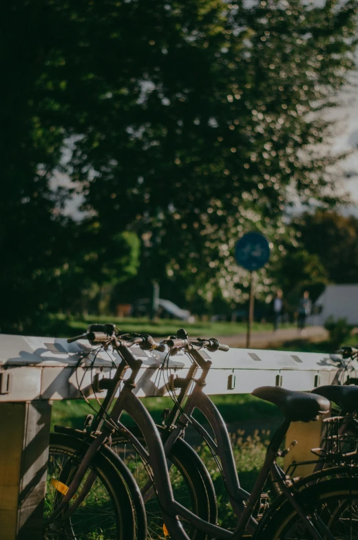 some bicycles are  to a white rail