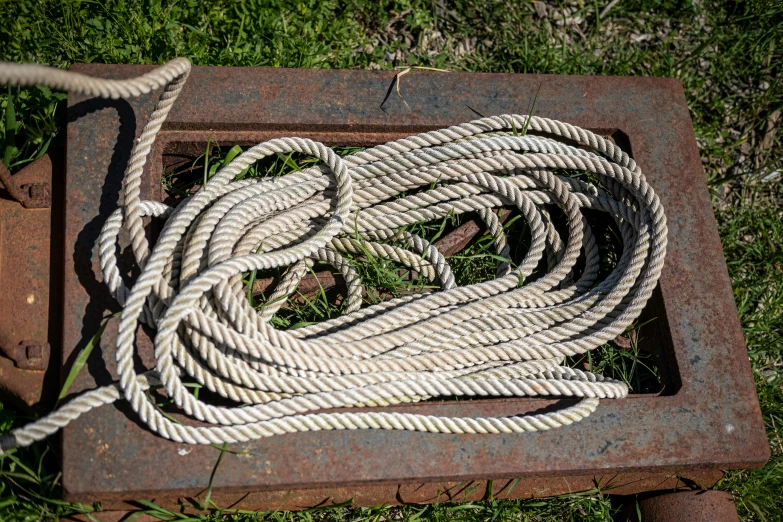 two ropes laying on a square steel grate