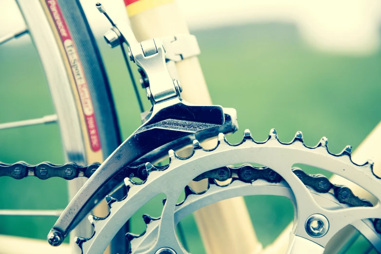 a close up of a bicycle's chain, showing its metal components