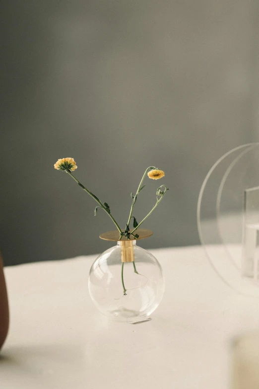 two vases filled with flowers sitting on a table