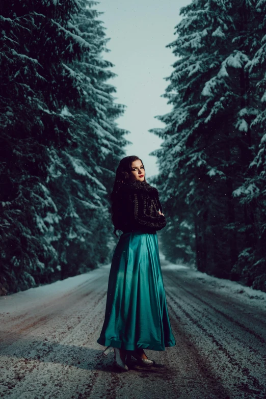 a woman is standing in front of trees