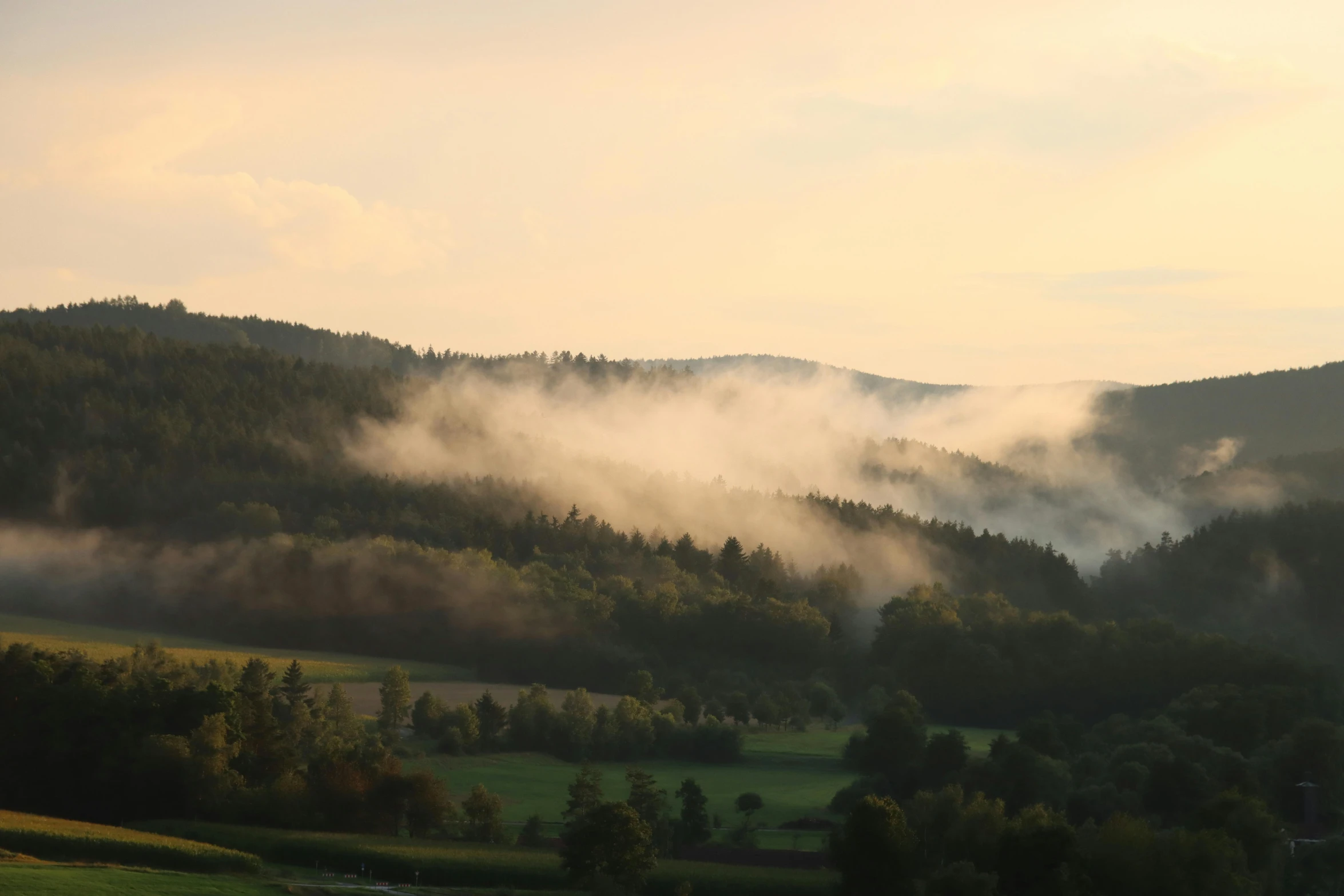 the fog rolling over the mountains at dawn