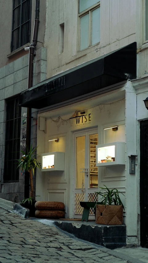 store front in a european city with brick paved streets