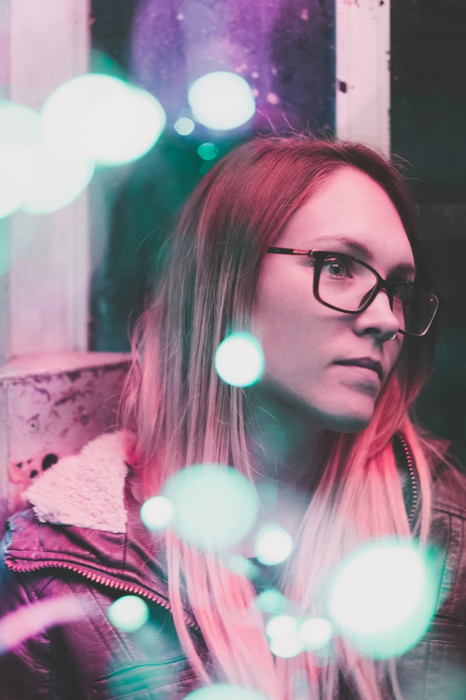 a young lady with long hair wearing glasses