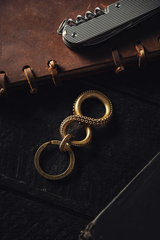a pair of golden rings is laying on the leather