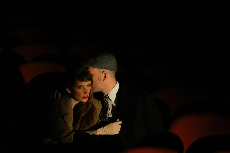 a man and a woman sitting together in a theater