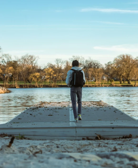 a person walking along the edge of a body of water