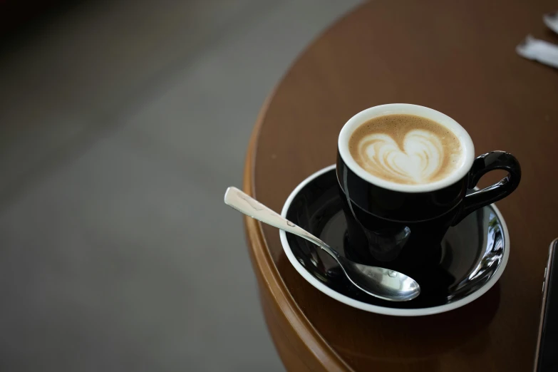 a cup with a spoon and a spoon sitting in it