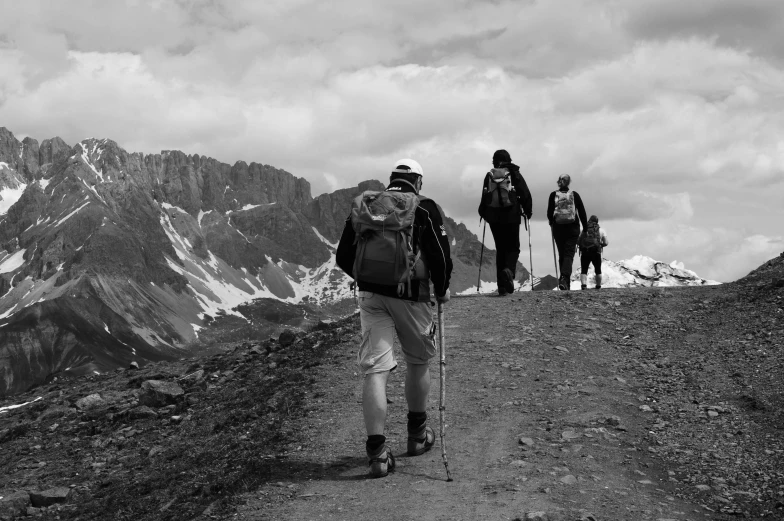 black and white pograph of three hikers on the side of a mountain