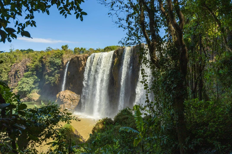 a man riding a horse under a waterfall