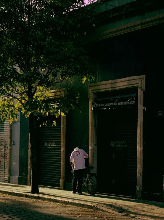 an old woman stands on the sidewalk holding her umbrella