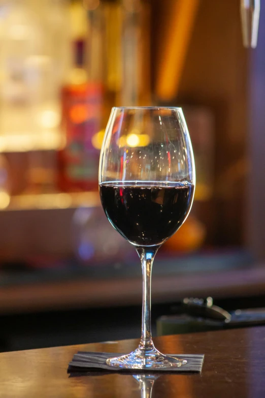 a close up of a wine glass on a table