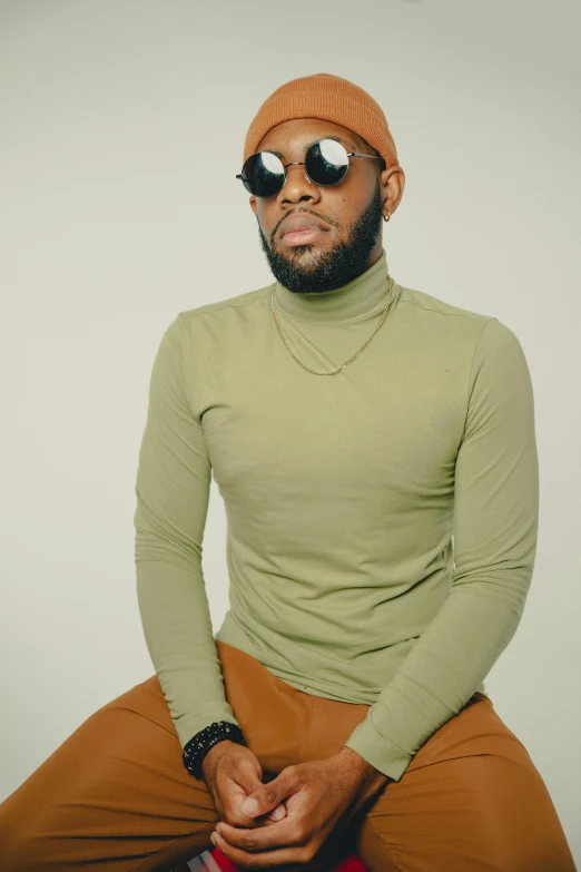 a young man with sunglasses and a knitted hat