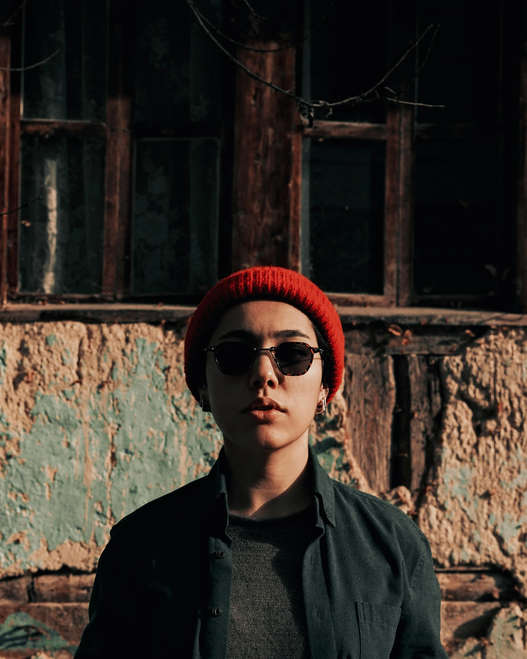 young man wearing sunglasses and red hat posing for picture