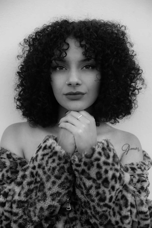 a woman with an afro is posing for the camera