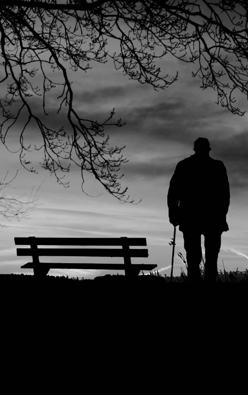 a person stands in the distance while standing next to a bench