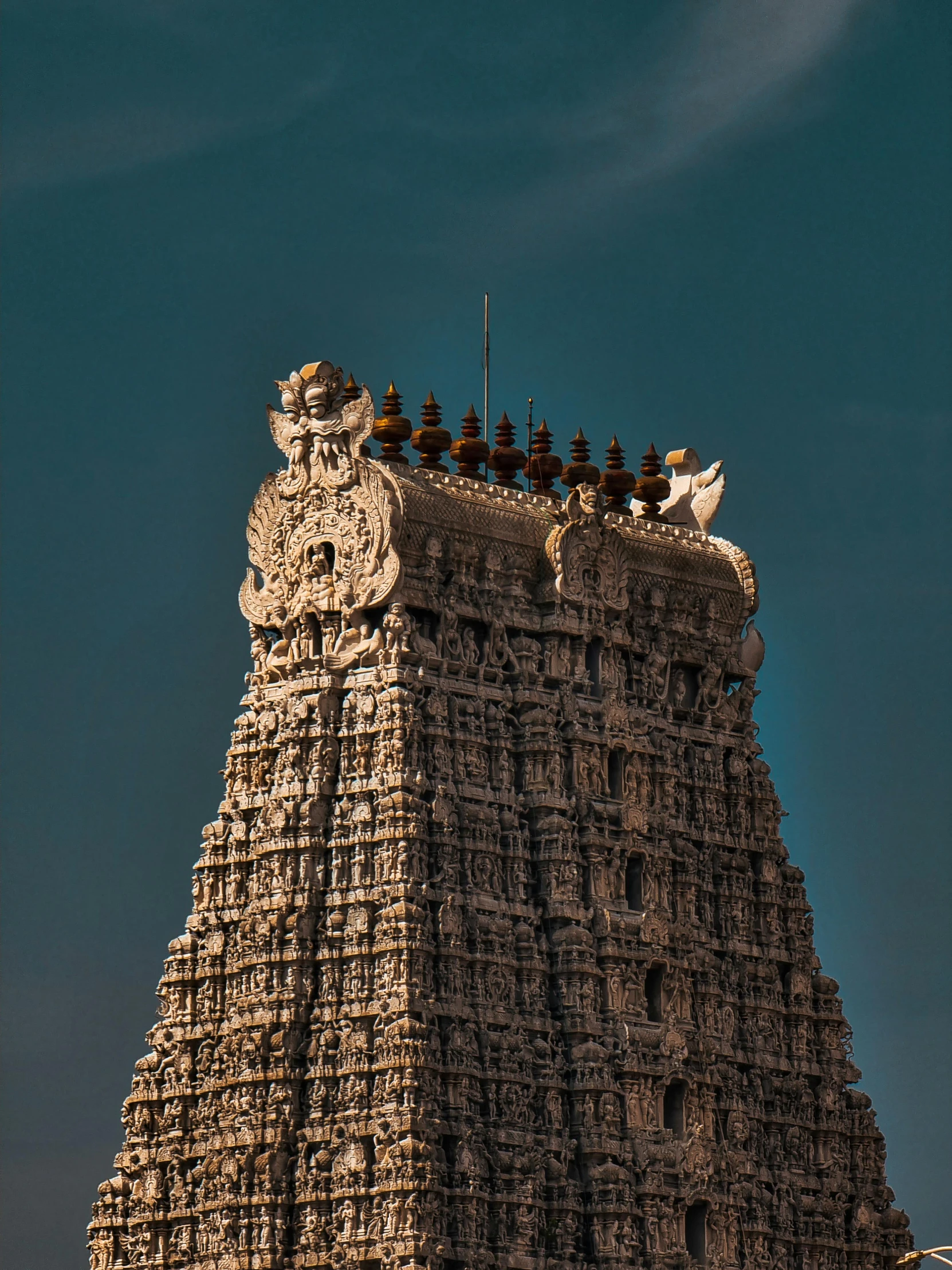 the top of an ornate tower with a sky background