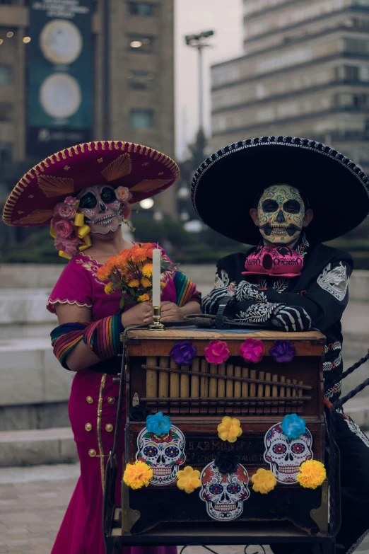 two people dressed in sombreras and skulls and one with a knife