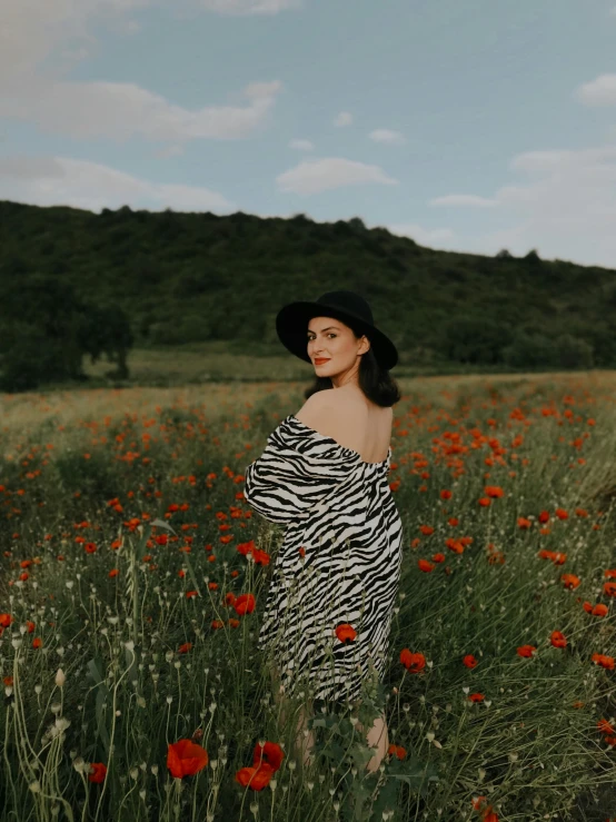 a woman posing in a field of wildflowers