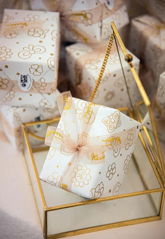 three wrapped gifts sitting on top of some glass