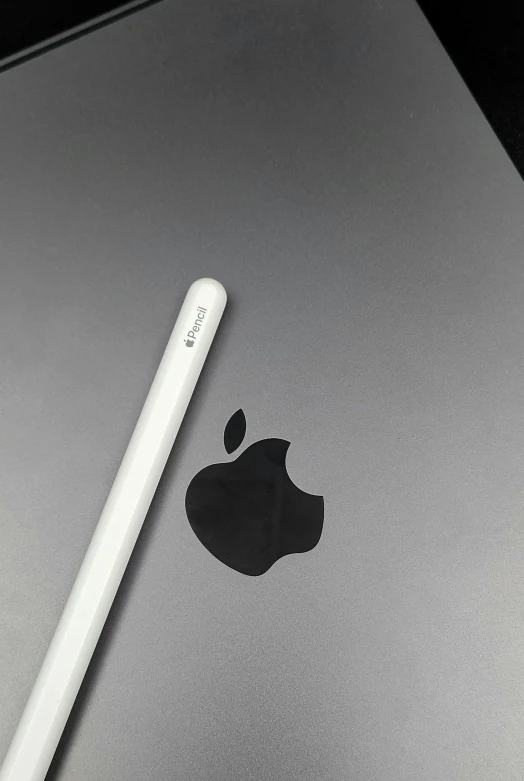 an apple logo and the stylus from an apple laptop