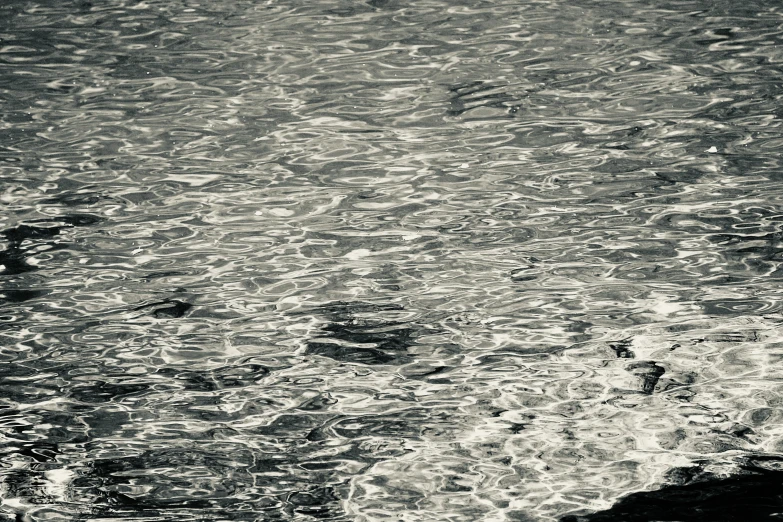 a man walking on the beach with an umbrella