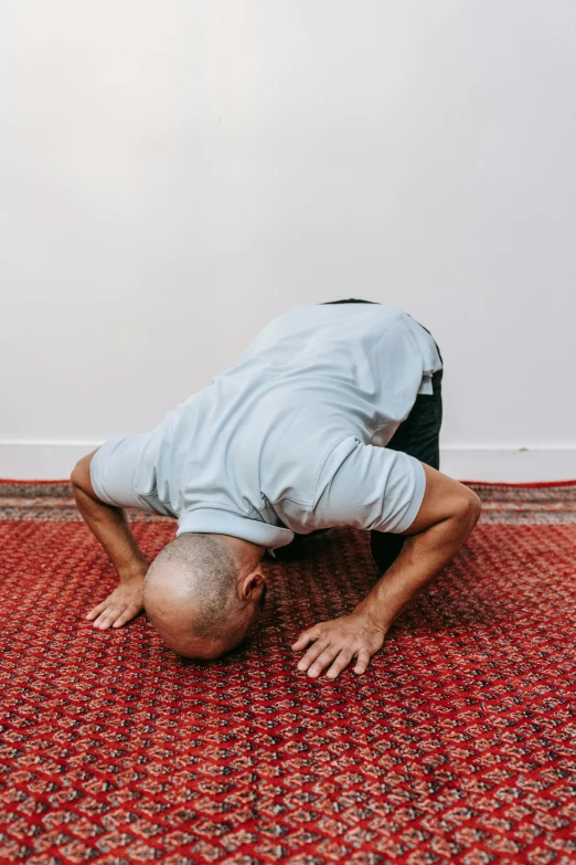 a man in the middle of a pose on a rug