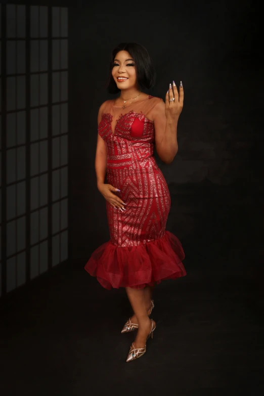 woman in red sequin dress posing for pograph