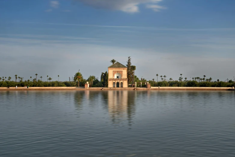 a small church sits on the edge of a lake