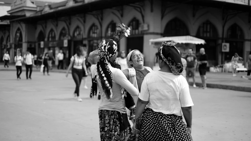 two women in skirts are walking around