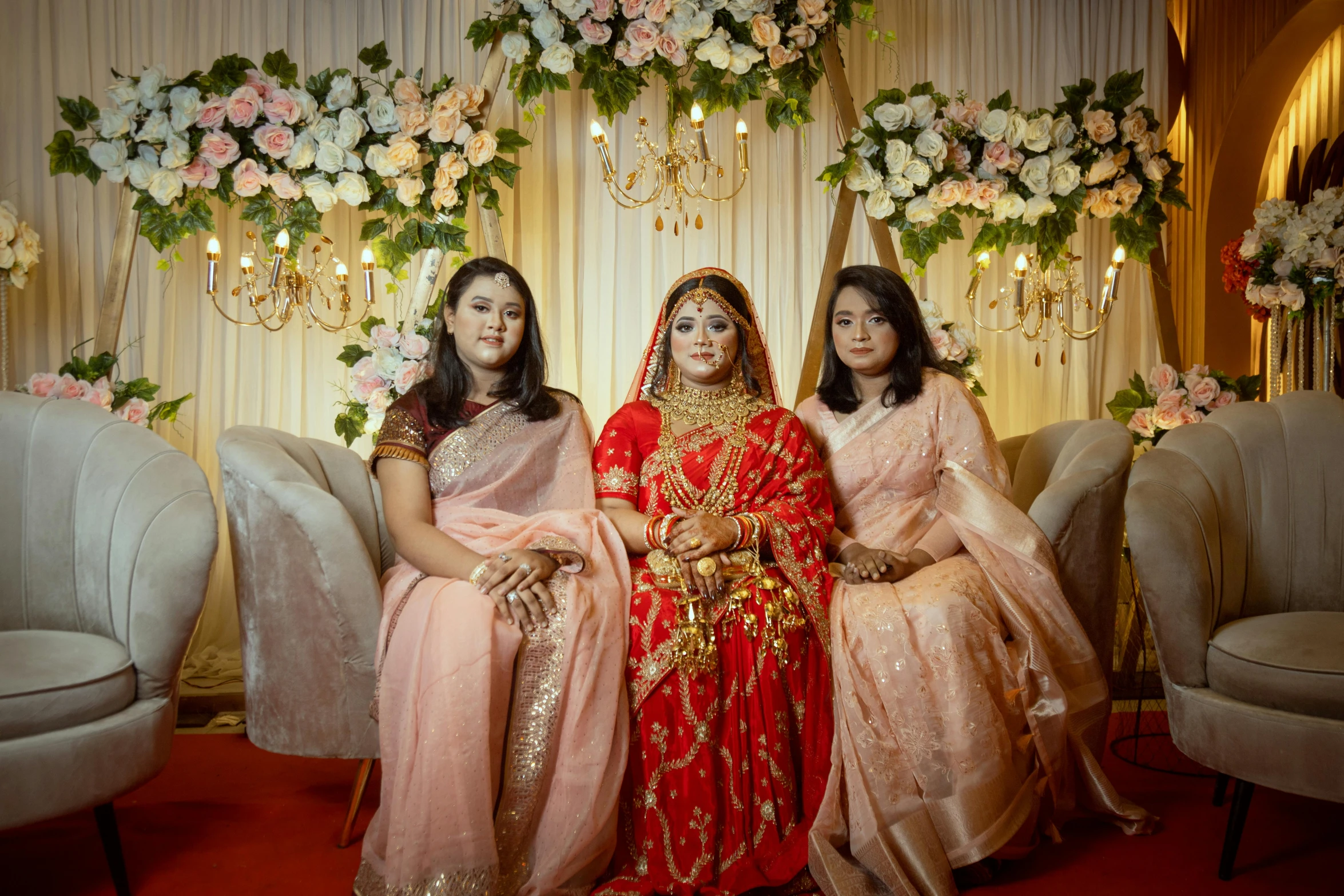 three women dressed in indian clothing standing together