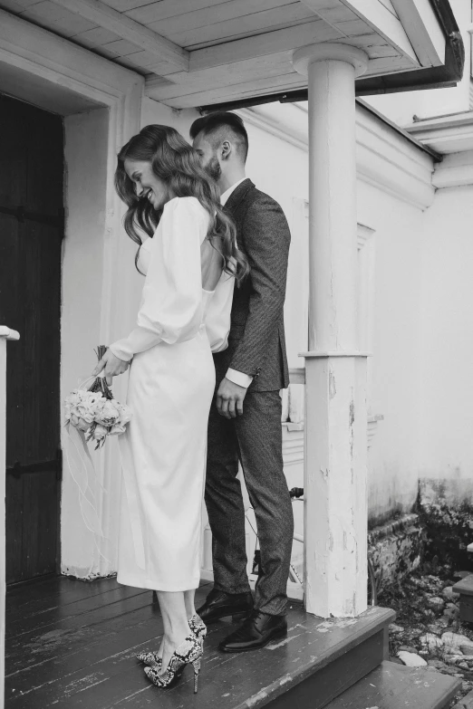 a man and woman standing next to each other on steps