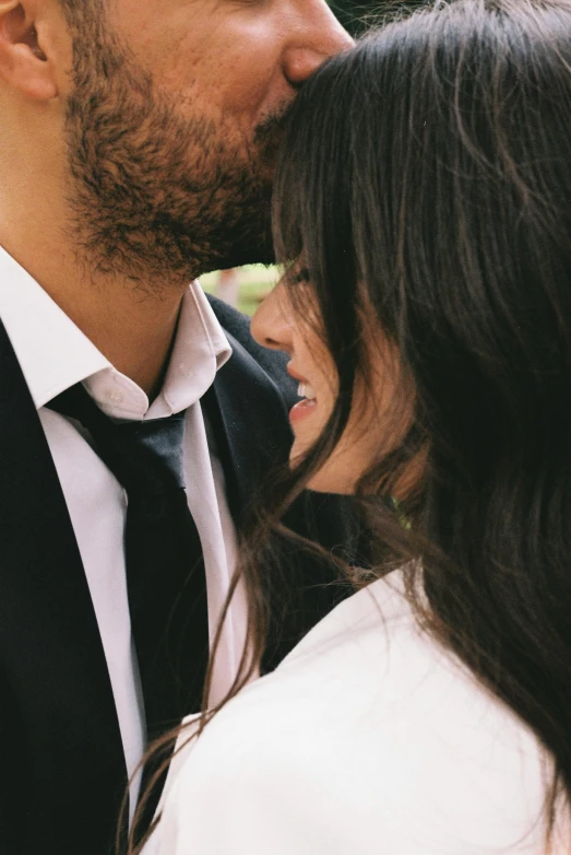 a man and woman emcing and kissing each other