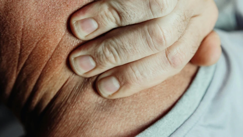 a close up of an unrecognizable hand on someones chest