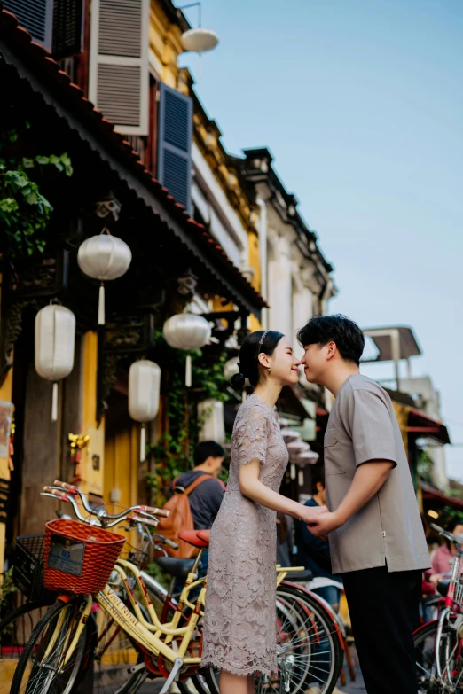 a man and woman standing next to bikes