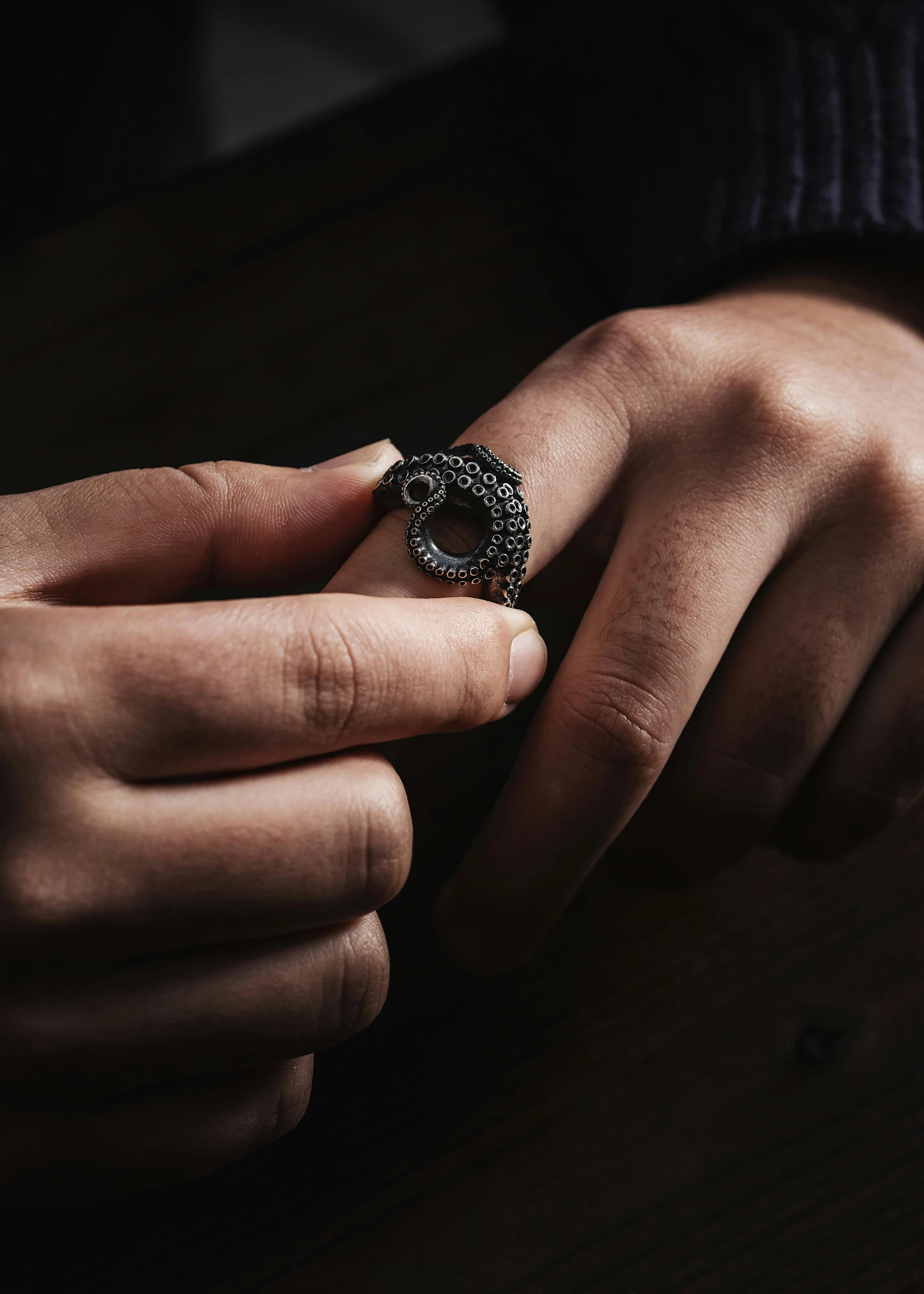 a person is holding an antique ring with diamonds on it